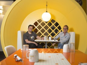 Peter Hribar, interior designer, right, and Mauro Martina, owner, sit in one of the unique breakfast-themed booths at OEB Breakfast Co.'s new Fifth Avenue Place location in Calgary.