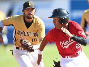 Okotoks Dawgs Josh McIntyre is tagged out at second base by Nick Spillman of the Edmonton Prospects during a double steal in game 1 of the first round of the WMBL playoffs in Okotoks, south of Calgary, on Aug. 1, 2016.