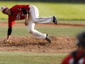 Okotoks' Nick Vickers slips while pitching during Game 4 of the Western Major Baseball League playoff series between the Edmonton Prospects and the Okotoks Dawgs at Telus Field in Edmonton, Alberta on Aug. 3, 2016.