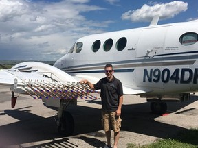 Weather Modification Inc. chief pilot Jody Fischer poses with his cloud seeding plane on Aug. 4, 2016. Fischer and his 10 fellow pilots spend their summers busting hail in the skies of southern Alberta.