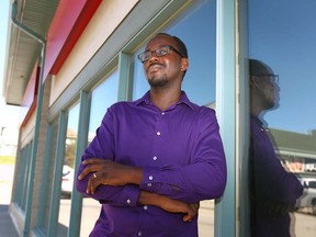 Timothy Afolayan, past payday loan user poses outside a northwest Calgary bank on Tuesday, Aug. 2. Afolayan applauds the new Alberta government program to help payday loan users.