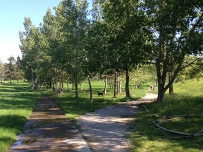 People walk with a dog at the closed Highland golf course.