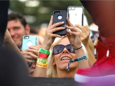 Phones aimed as Dustin Lynch struts on the catwalk as he performs at day 3 of Country Thunder at Prairie Winds Park in Calgary, Ab., on Sunday August 21, 2016. Mike Drew/Postmedia
