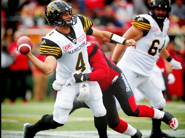 Calgary Stampeders Charleston Hughes brings down quarterback Zach Collaros of the Hamilton Tiger-Cats during CFL football in Calgary, Alta., on Sunday, August 28, 2016. AL CHAREST/POSTMEDIA