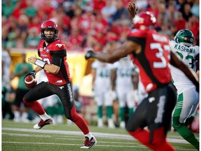 Calgary Stampeders Bo Levi Mitchell scrambles to make a pass to Jerome Messam against the Saskatchewan Roughriders during CFL football in Calgary, Alta., on Thursday, August 4, 2016.