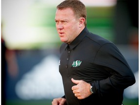 Saskatchewan Roughriders head coach Chris Jones runs onto the field before a game against the Calgary Stampeders in CFL football in Calgary, Alta., on Thursday, August 4, 2016.