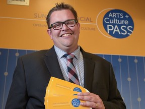 Paul McIntyre Royston, president and CEO of the Calgary Public Library Foundation, shows off some new Arts + Culture Passes at Calgary Central Library in Calgary, Alta., on Tuesday, Aug. 2, 2016. The pass, available to qualified low-income Calgarians, is "like a library card to the city, except you don't have to return anything," said McIntyre Royston. Elizabeth Cameron/Postmedia