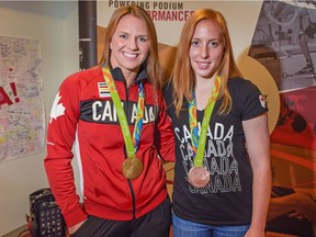 Rio Olympics gold-medalist in Women's Freestyle 75kg Wrestling Erica Wiebe and bronze-medalist in Track Cycling Allison Beveridge pose with their medals at the Markin MacPhail Centre in Calgary on Aug. 31, 2016.
