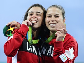RIO-OLYMPICS-POSTMEDIA - Meaghan Benfeito (L) and Roseline Filion of Canada celebrate their bronze in the women's 10m synchro diving at the Rio 2016 Olympics in Rio de Janeiro, August 09, 2016.  Photo by Jean Levac