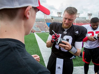 Calgary Stampeders quarterback Bo Levi Mitchell signs autographs for Make-A-Wish Foundation kids after a Calgary Stampeders practice in Calgary, Alta., on Thursday, Aug. 25, 2016. About 30 kids with the Make-A-Wish Foundation of Southern Alberta watched a team practice, toured the Stampeders' locker room and met the players.