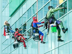 Thor, Ironman, Spiderman and the Hulk wash windows at the Alberta Children's Hospital in Calgary on Wednesday, Aug. 24, 2016. The washers refused to identify their secret identities, opting instead to wow kids through windows while cleaning the hospital's exterior.