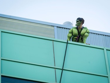 The Hulk sets a rappel line before washing windows at the Alberta Children's Hospital in Calgary, Alta., on Wednesday, Aug. 24, 2016. Four superhero window washers refused to identify their secret identities, opting instead to wow kids through windows while cleaning the hospital's exterior.