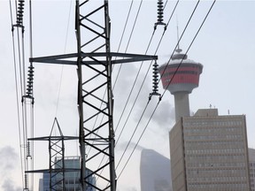 Downtown Calgary is framed by electrical power lines.