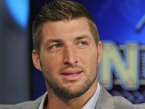 Tim Tebow ponders a question during an interview on the set of ESPN's new SEC Network in Charlotte, N.C., in 2014.