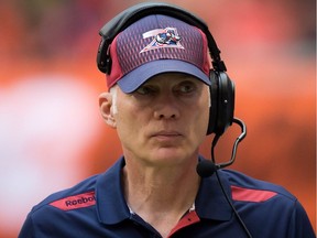 Montreal Alouettes head coach Tom Higgins walks the sideline during first half CFL action against the B.C. Lions in Vancouver on July 19, 2014.