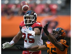 B.C. Lions' Shawn Gore, right, fails to make the reception as Calgary Stampeders' Tommie Campbell defends during the first half of a CFL football game in Vancouver, B.C., on Friday August 19, 2016.