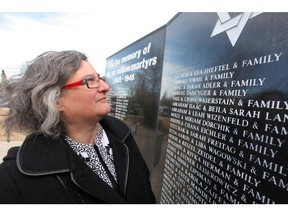 Judy Shapiro of the Calgary Jewish federation stands in front of the Ashes to Life Holocaust memorial. The memorial was a destination for Pokemon Go players.