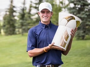 Charlie Bull holds the championship trophy after rain prompted an early ending to the ATB Financial Classic at Country Hills Golf Club in Calgary on Aug. 7, 2016. Play was cancelled on Sunday due to flooding from the night before. Courtesy of ATB Financial Classic