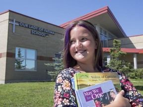 Chiara Taylor, fifth grade, stands outside Our Lady of Fatima school where she attends its year round classes in Calgary, on August 2, 2016. (Crystal Schick/Postmedia)