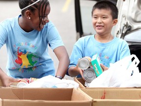 YMCA day campers help unload food for its annual drive for the Calgary Food Bank. Leah Hennel/Postmedia