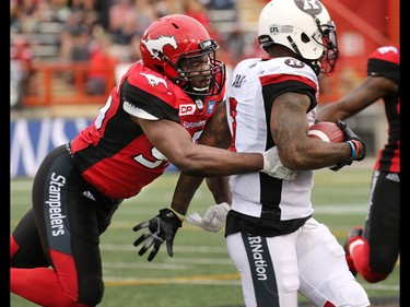 The Calgary Stampeders defensive lineman Ja'Gared Davis moves to tackle the Redblacks' Travon Van during the second half of CFL football action between the Stampeders and Ottawa Redblacks at McMahon Stadium in Calgary on Saturday September 17, 2016.
