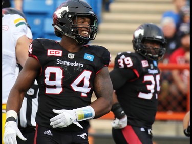 Calgary Stampeders defensive lineman Frank Beltre smiles after stopping an Edmonton Eskimos play in the second half of the CFL Labour Day Classic in Calgary on Monday September 5, 2016.