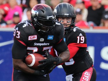 Calgary Stampeders running back Jerome Messam takes a hand off from Bo Levi Mitchell in the fourth quarter of the CFL Labour Day in Classic Calgary on Monday, Sept.5, 2016.