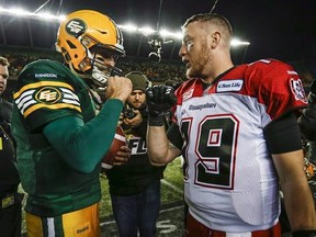 Calgary Stampeders quarterback Bo Levi Mitchell, right, and Edmonton Eskimos quarterback Mike Reilly embrace following the CFL West Division final in Edmonton, Sunday, Nov. 22, 2015. Labour Day&#039;s Battle of Alberta in the CFL will showcase of the top two quarterbacks in the league. Edmonton&#039;s Reilly and Calgary&#039;s Mitchell rank first and second respectively in passing yards and touchdown throws at the halfway mark of the season. THE CANADIAN PRESS/Jeff McIntosh