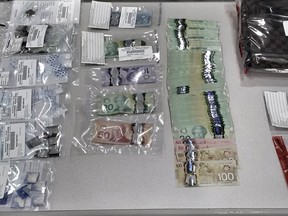 Some of the illegal items, and proceeds from allegedly selling them, seized during an ALERT investigation into street-level drug sales in Calgary.