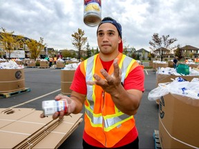 Volunteer Ephraim Peihopa from the LDS Church in Cranston tries his hand at juggling at a drop-off spot for donations to the Calgary Food Bank in Calgary, Ab., on Saturday September 17, 2016. Mike Drew/Postmedia