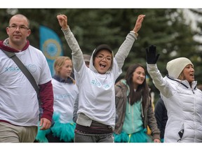 Cheering erupts as a group crosses the finish line at the Ovarian Cancer Walk of Hope in Calgary, Alta., on Sunday, Sept. 11, 2016. Elizabeth Cameron/Postmedia