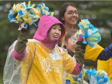 Volunteers cheer as participants in the Ovarian Cancer Walk of Hope finish at North Glenmore Park in Calgary, Alta., on Sunday, Sept. 11, 2016. Elizabeth Cameron/Postmedia