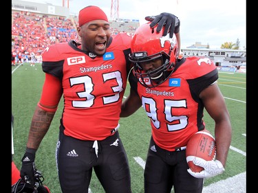The Calgary Stampeders defensive lineman Ja'Gared Davis is congratulated by running back Jerome Messem after Davis recovered a fumble to make a touchdown in the second half of  CFL football action between the Stampeders and Ottawa Redblacks at McMahon Stadium in Calgary on Saturday September 17, 2016.