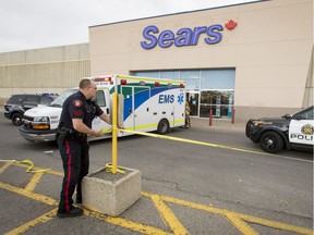 An ambulance and police vehicle sit outside of Sears in Marlborough Mall in Calgary on Saturday, Sept. 17, 2016.