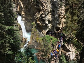 People line up to enter the cave at Johnston Canyon in Banff National Park in July 2016.
