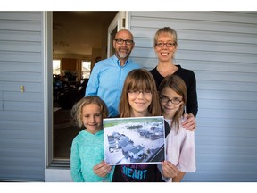 Because of the generosity shown to them when their home was flooded in 2013, High River residents Terry and Helga Lempriere and their daughters Chelsey, 6, Rachel, 10, and Cailyn, 8, are collecting Christmas  ornaments for families in fire-ravaged Fort McMurray.