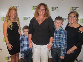 Cal 0917 Never 2  Pictured at The Wood's Homes Foundation Never Give Up Gala held Sept 10 at the Hyatt  are gala co-chairs Ellie Smith (left) and kata Acheson (right) with keynote speaker Claire Parker and her sons Jake Rempel (left) and Drew Rempel. Parker's family  story of struggle and courage drew a standing ovation.