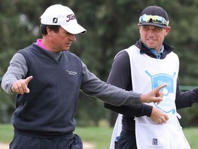 Calgary golf pro Dustin Risdon, right, chats with Spain's Miguel Angel Martin as he caddys for him at the Shaw Charity Classic at the Canyon Meadows Golf Club in Calgary on Sunday September 4, 2016. Gavin Young/Postmedia