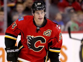 New Jersey Devils center Reid Boucher, left, competes for the puck with Calgary Flames defenceman Dennis Wideman on Jan. 19, 2016, in Newark, N.J. (AP Photo)