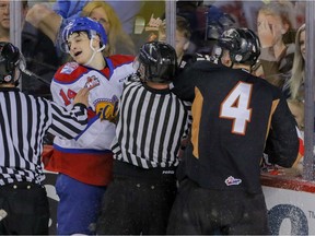 Calgary Hitmen Micheal Zipp mixes it up with Edmonton Oil Kings Davis Murray in WHL action at the Scotiabank Saddledome in Calgary, Alberta, on Saturday, September 10.