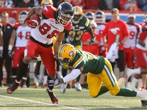 Calgary Stampeders DaVaris Daniels gets around a tackle by Edmonton Eskimos Kenny Ladler during CFL action at McMahon Stadium in Calgary on June 11, 2016.