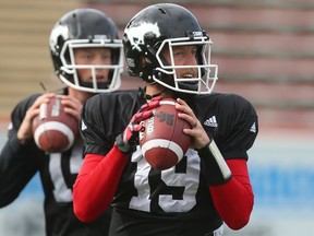 Calgary Stampeders QBs Bo Levi Mitchell (R) and Andrew Buckley throw during practice at McMahon Stadium in Calgary, Alta.. on Sept. 28, 2016.