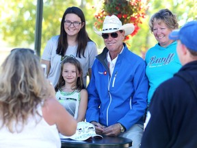 Canadian legend Ian Millar poses with young fans from the left, Erin, Sydney and Tanya Cassels during an autograph session Sept. 9, 2016 at Spruce Meadows during The Masters.