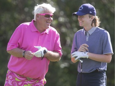John Daly jokes with Logan Shaw after the youngster hit an errant drive towards the spectators off the 10th tee during the RBC Championship Pro-Am in the Shaw Charity Classic at Canyon Meadows Golf Club Thursday September 1, 2016.