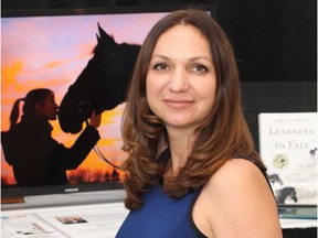 Author Anne Clermont with her book Learning To Fall, and a video trailer for it, in the Gallery on the Green at Spruce Meadows Friday September 9, 2016 during The Masters. The story is partially set at Spruce Meadows. She is a Canadian living in the Seattle area.