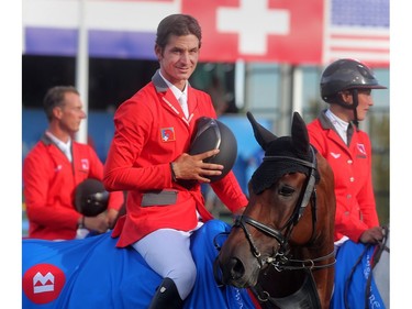 Steve Guerdat takes his helmet off for the  national anthem of Switzerland after he and his teammates earned a Swiss victory in the BMO Nation's Cup Saturday September 10, 2016 during The Masters at Spruce Meadows.