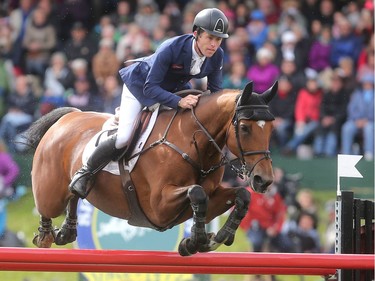 British rider Scott Brash clears the final fence to win the jump off and victory in the CP International Grand Prix, and it's $1million paycheque, Sunday September 11, 2016 on the final day of the Spruce Meadows Masters.