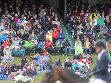 A hardy crowd braves cold and rain to watch CP International Grand Prix Sunday September 11, 2016 on the final day of the Spruce Meadows Masters.