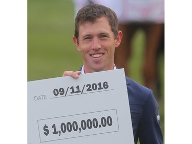 British rider Scott Brash holds his $1million paycheque after winning the CP International Grand Prix and it's Sunday September 11, 2016 on the final day of the Spruce Meadows Masters.