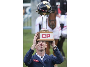 British rider Scott Brash holds up the trophy  after winning the CP International Grand Prix, and it's $1million paycheque, Sunday September 11, 2016 on the final day of the Spruce Meadows Masters.